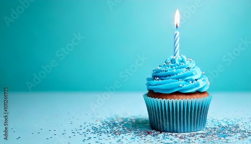 Blue birthday cupcake with sprinkles on blue background
