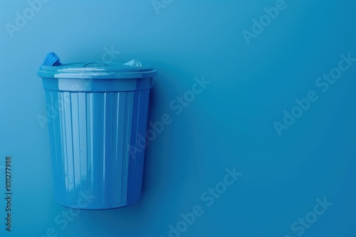 A blue trash can rests against a blue wall in a minimalist indoor setting during daylight