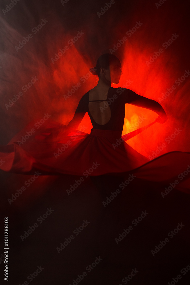 Fototapeta premium Silhouette of a woman in a red skirt dancing Latin in smoke in neon light. Dance concept. Bachata, Latina