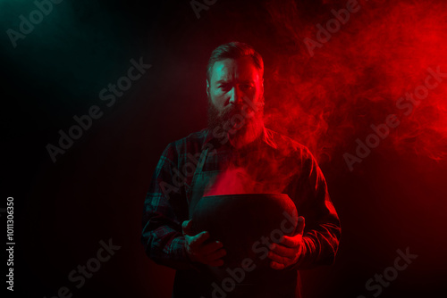 Photo of angry cruel wizard warlock hold cauldron magic ritual spooky night isolated on dark misty mysterious background