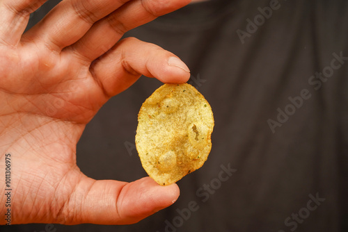 Man eating potato chips. Fast food. Unhealthy lifestyle Junk food. Hands hold potato chip. Calories. Obesity. American food. Okay sign.