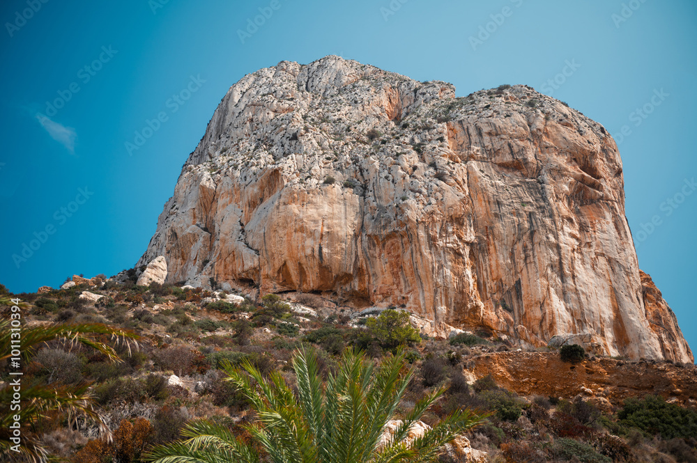 Majestic rocky cliff under a clear blue sky Majestic rocky cliff under a clear blue sky