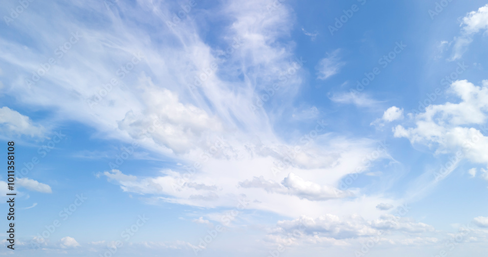 A breathtaking view of a clear blue sky with fluffy clouds, perfect for background use in design projects, illustrating serenity and peace.