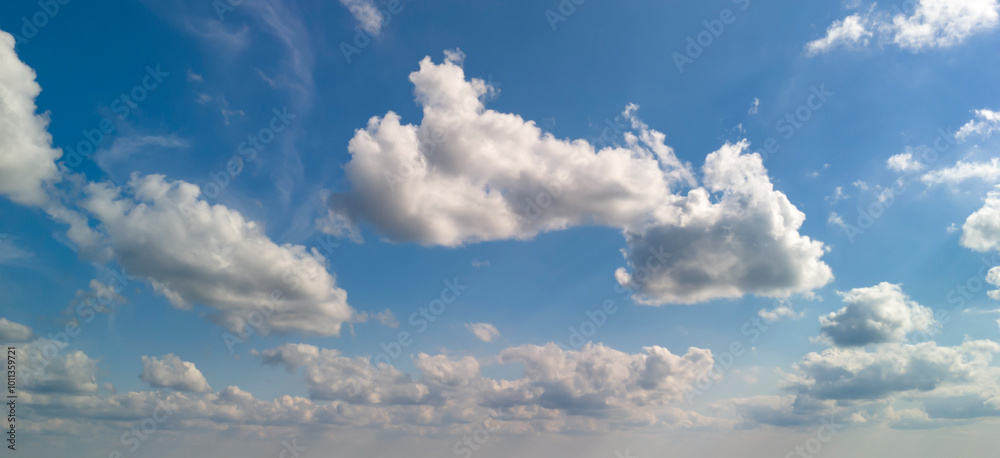 A serene view of fluffy white clouds against a bright blue sky, perfect for conveying tranquility and openness. A serene view of fluffy white clouds against a bright blue sky, perfect for conveying tranquility and openness.
