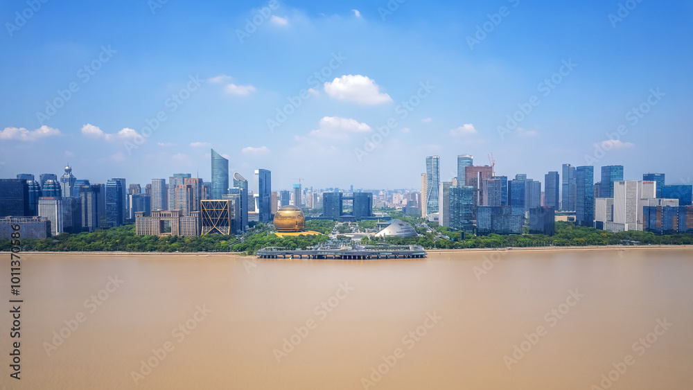 Naklejka premium Aerial View of Modern Cityscape by the River Under Clear Blue Sky
