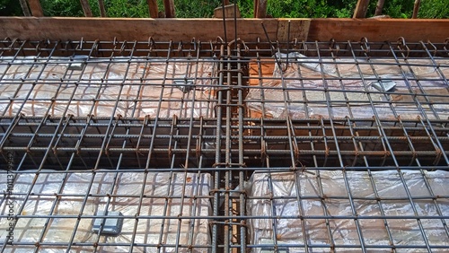 Iron fittings on wooden formwork for house floor with concrete slab