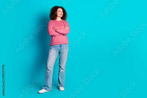 Full body portrait of nice young girl crossed hands look empty space isolated on turquoise color background