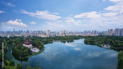 Panoramic View of a Serene Urban Lake with Lush Greenery