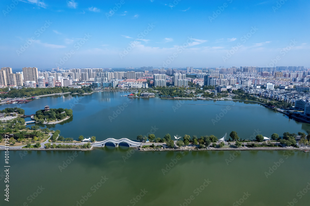 Fototapeta premium Aerial View of a Serene City Park Surrounded by Urban Landscape