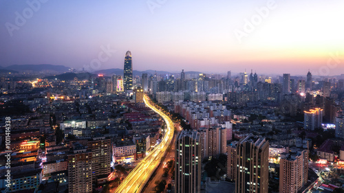 Breathtaking Urban Skyline at Sunset with City Lights Illuminating the Streets