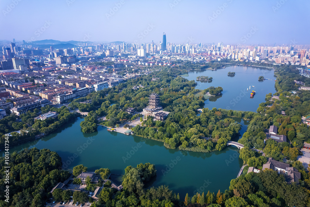 Fototapeta premium Aerial View of Cityscape with Lush Greenery and Serene Waterways
