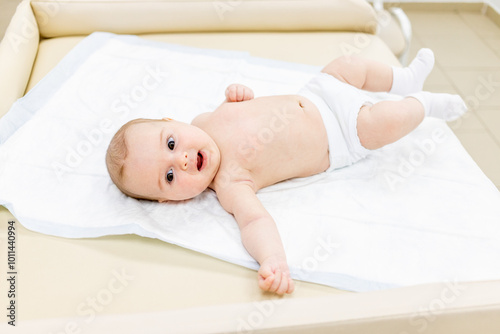 a small child is being examined by a doctor in a polyclinic photo