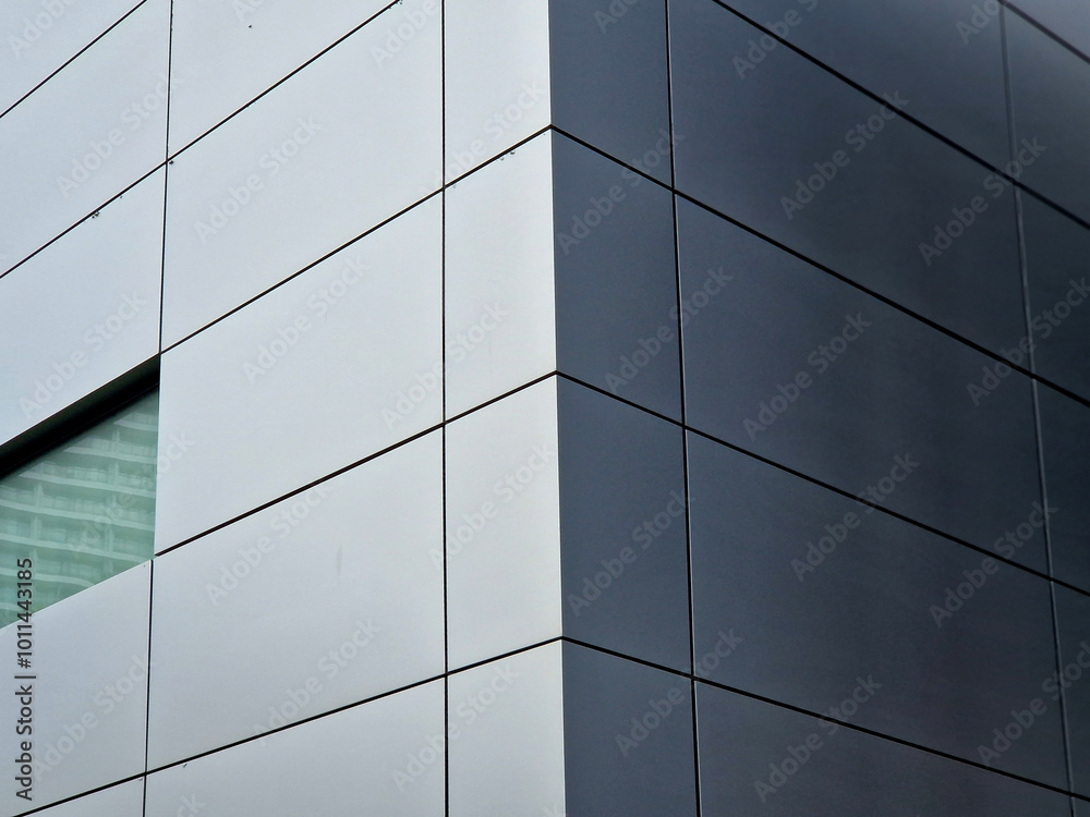cladding of a building with a expanded metal lattice structure. galvanized gray nets protect the industrial building. Blue sky in contrast to a silver background, wall, corner, slanted, sheet metal