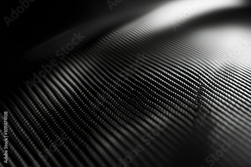 Close-up of a Black Textured Surface with Parallel Lines and Light Reflection