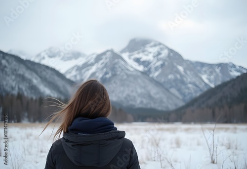 A young woman admiring the snowy views of Island Lake in Fernie, British Columbia, Canada. The majestic winter background is an absolutely beautiful place to go snowshoeing with fresh fallen snow.
 photo