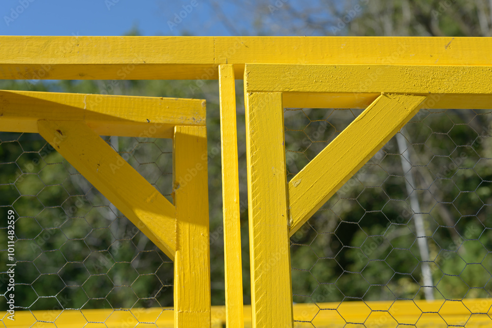 detail of a wood frame painted yellow on a defocused background detail of a wood frame painted yellow on a defocused background