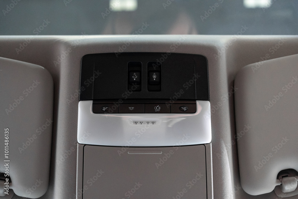 Elegant car lighting control panel with buttons for interior lighting and system deactivation. Modern design and convenient layout offer comfort and intuitive control for both driver and passengers Elegant car lighting control panel with buttons for interior lighting and system deactivation. Modern design and convenient layout offer comfort and intuitive control for both driver and passengers