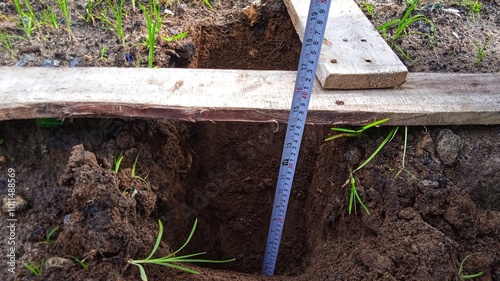 Measuring the depth of a trench dug for a culvert