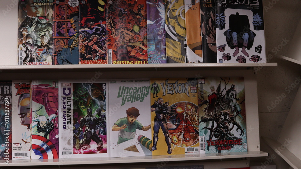 Obraz premium CARDIFF, MID GLAMORGAN, WALES UK - OCTOBER 3, 2024: COMIC BOOKS ON SHELVES DISPLAY PAPERBACKS 