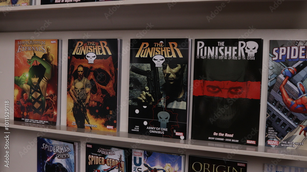 Obraz premium CARDIFF, MID GLAMORGAN, WALES UK - OCTOBER 3, 2024: PUNISHER COMIC BOOKS ON SHELVES DISPLAY PAPERBACKS
