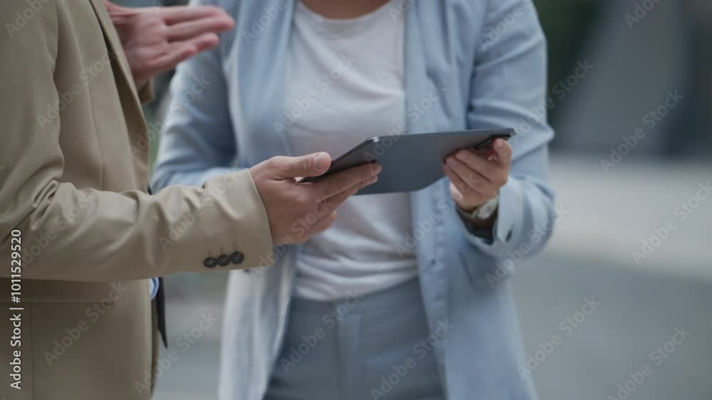 Businesspeople using digital tablet discussing slow motion