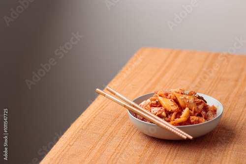 Kimchi, Kimchee in the Bowl, Red Spicy Kim Chi, Hot Fermented Napa Cabbage, Traditional Jimchi on a table photo