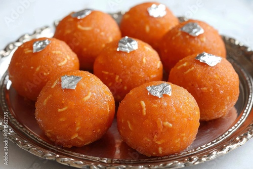 Orange and Silver-Topped Round Sweets on a Silver Platter