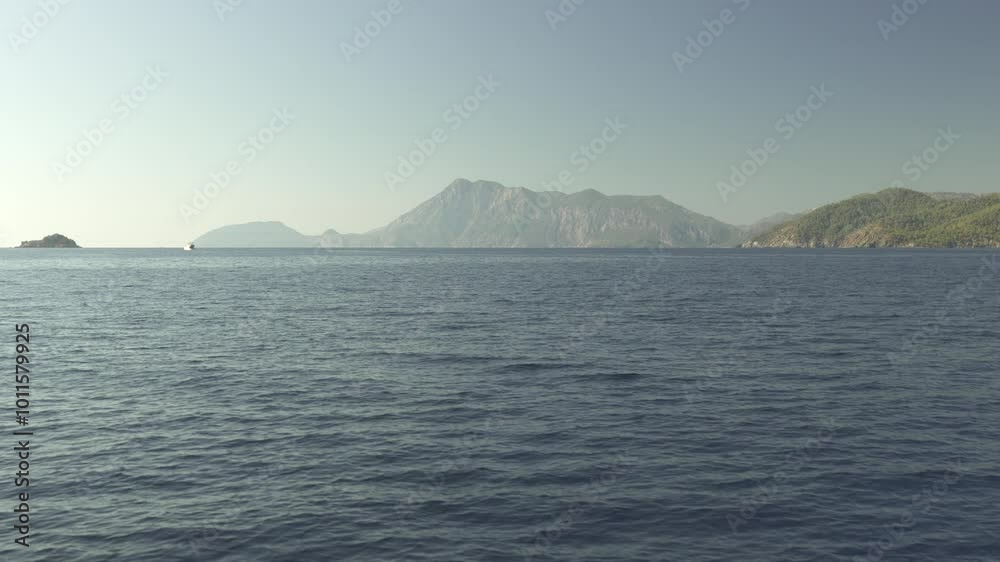 Open Calm Sea and Scenic Rock View from the Deck of a Moving Yacht Open Calm Sea and Scenic Rock View from the Deck of a Moving Yacht