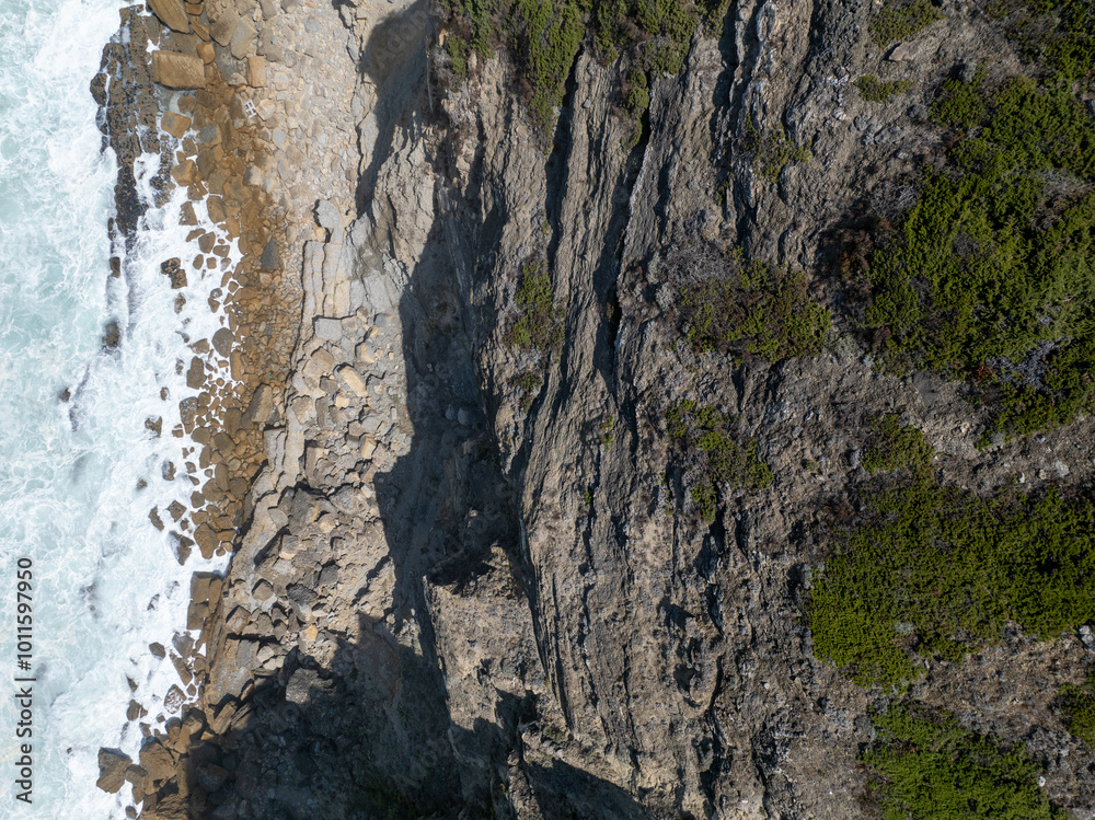 The rugged coastline of a dramatic cliffside The rugged coastline of a dramatic cliffside