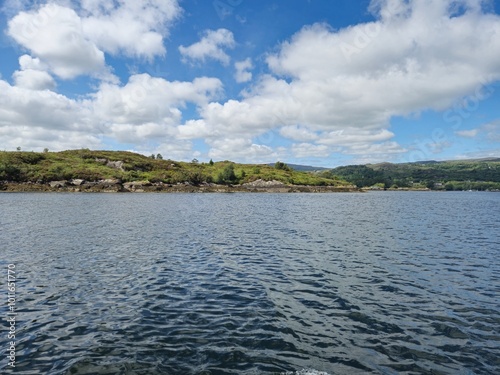 Tranquil Waterscape: A Peaceful River With Little Waves And Cloud Reflections