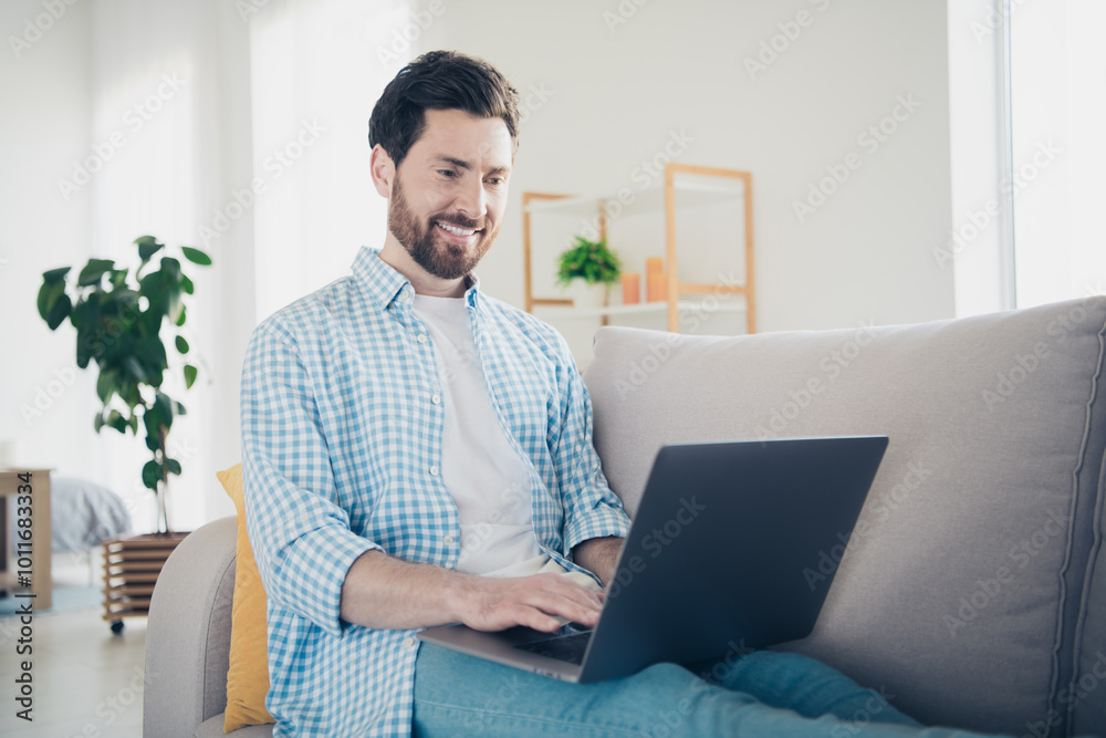 Photo of handsome bearded alone mature age adult man staying home working remote specialist programming indoors using laptop Photo of handsome bearded alone mature age adult man staying home working remote specialist programming indoors using laptop