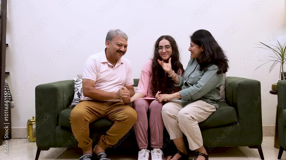 Happy Indian Family Bonding on Couch - Parents and Daughter Together
Happy Indian Family Bonding on Couch - Parents and Daughter Together