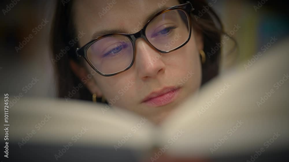 A Focused Reader Deeply Enjoying a Book Comfortably Seated in a Cozy, Inviting Setting A Focused Reader Deeply Enjoying a Book Comfortably Seated in a Cozy, Inviting Setting