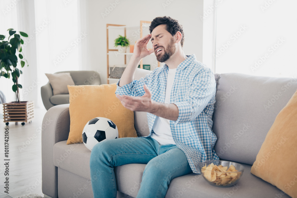Photo of handsome bearded alone mature age adult man staying home in living room touch forehead stressed watching bet lose Photo of handsome bearded alone mature age adult man staying home in living room touch forehead stressed watching bet lose