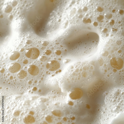 A macro shot capturing the texture of beer foam and bubbles, highlighting the smooth and frothy surface of the drink in rich detail. photo