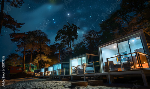 a beachfront vacation camp enclosed by multiple container houses large glass windows nightfall sparkling starry sky photo