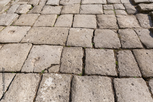 Ancient court lined with stone slabs in sunny weather photo