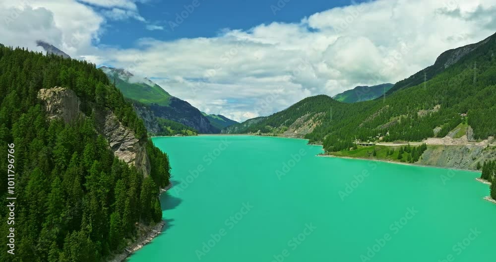 Water transport in Switzerland. Navigating a Swiss Lake. Aerial view steamboat ship on lake Interlaken. Switzerland summer tourism destination. Turquoise blue water. Swiss flag on a passenger ship Water transport in Switzerland. Navigating a Swiss Lake. Aerial view steamboat ship on lake Interlaken. Switzerland summer tourism destination. Turquoise blue water. Swiss flag on a passenger ship