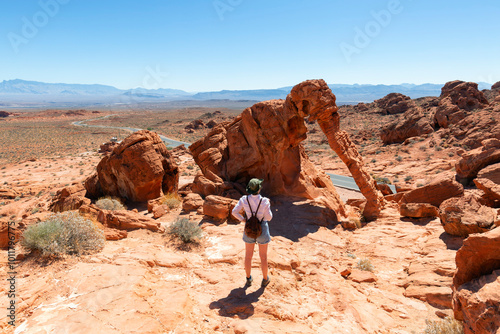 Girl standing on Elephant Rock at Valley of Fire State Park in a sunny day, Nevada, USA