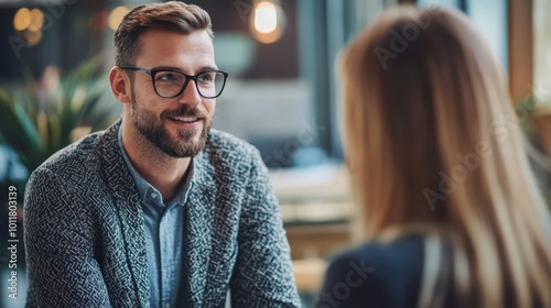 A young professional explores interest-free payment plans with a financial advisor in a modern office setting