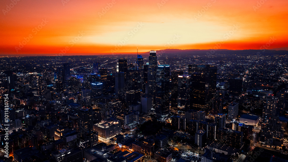 Obraz premium Vast panorama of a stunning Los Angeles, California, USA at twilight time. City scenery at the backdrop of orange sky. Aerial perspective.