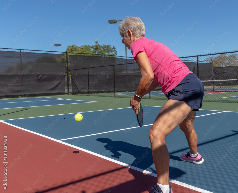 Obraz premium Award winning pickleball player hits a clean forehand volleya.