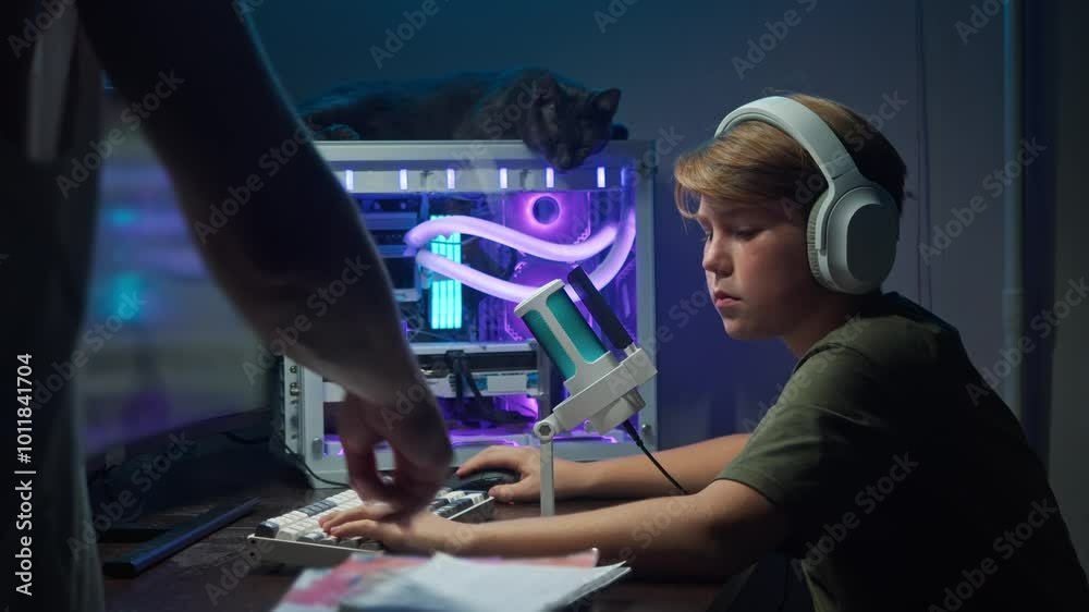 One of parents compels child to complete their homework by directing their attention to textbooks and notebook, rather than engaging in recreational activities on gaming computer. One of parents compels child to complete their homework by directing their attention to textbooks and notebook, rather than engaging in recreational activities on gaming computer.