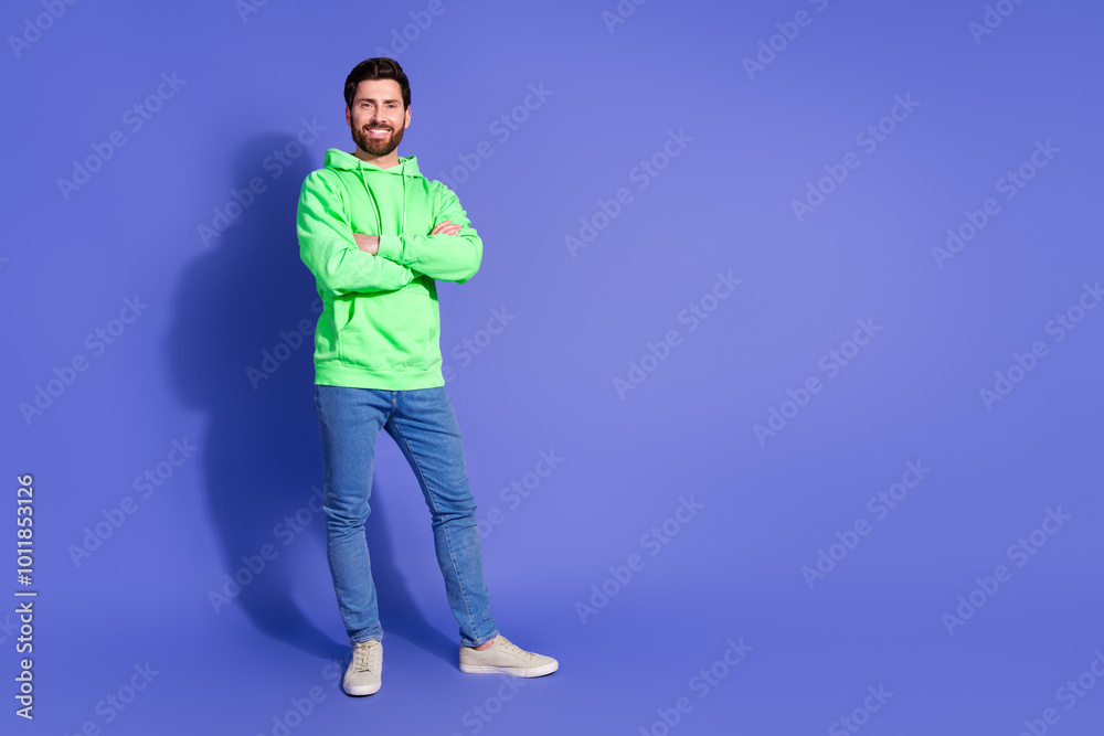 Full length photo of handsome young guy crossed hands confident dressed stylish green garment isolated on violet color background Full length photo of handsome young guy crossed hands confident dressed stylish green garment isolated on violet color background