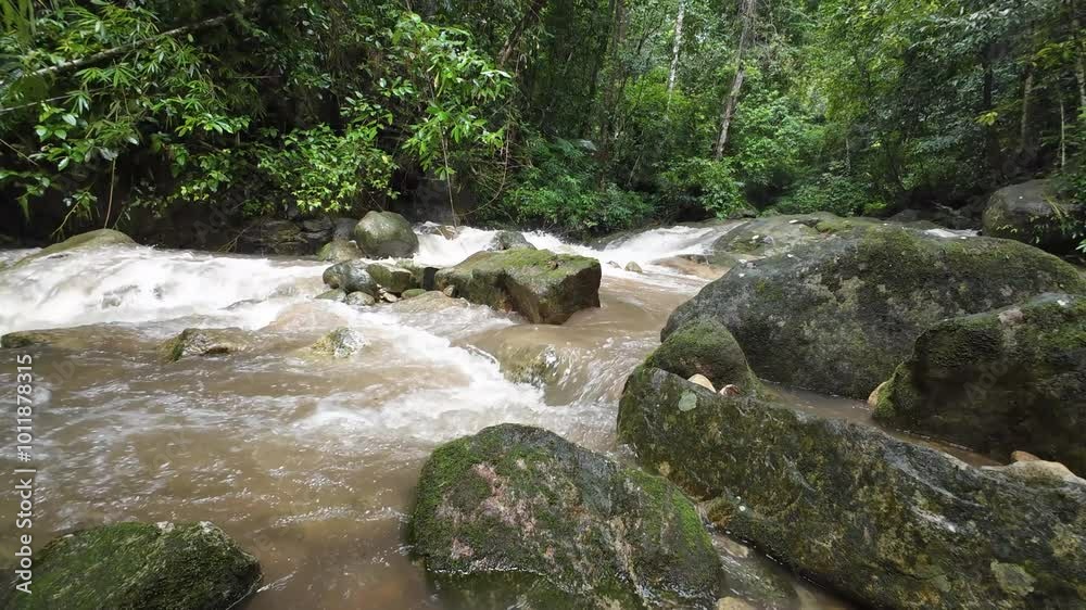 Waterfall in the rainy season has muddy red water flowing rapidly. Waterfall in the rainy season has muddy red water flowing rapidly.
