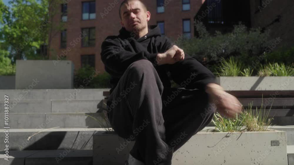 A hip-hop street dancer performs a dance, making expressive movements with tattooed hands. Self-expression through choreography and intricate, smooth hand movements and rhythmic body movements.