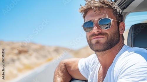 A man with sunglasses and beard in a car, enjoying a sunlit drive through a desert landscape with a serene and relaxed expression, capturing freedom and escape.