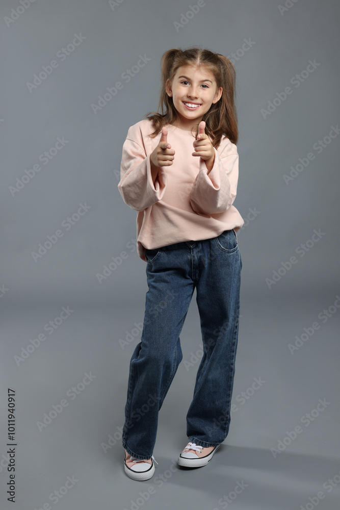 Full length portrait of cute girl on grey background Full length portrait of cute girl on grey background