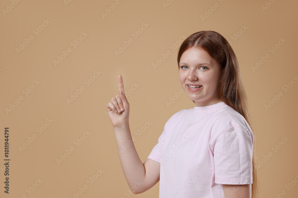 Portrait of teenage girl on beige background, space for text Portrait of teenage girl on beige background, space for text