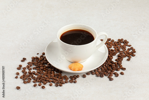 White cup of fresh brewed black coffee decorated with coffee beans